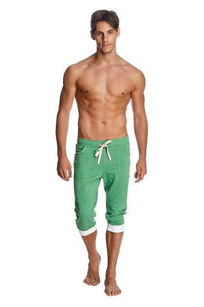 Green cuffed yoga pants made from bamboo fabric featuring white drawstring and cuffs for comfortable wear