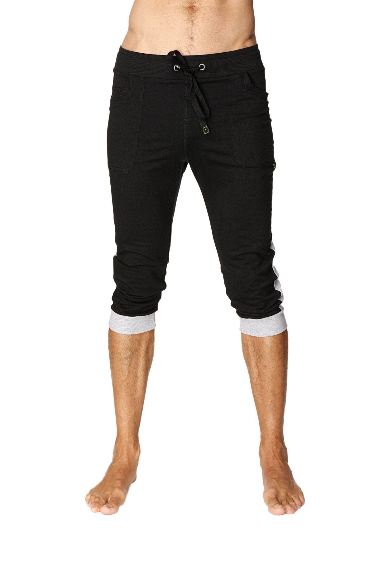 Black cuffed yoga pants featuring capri-length joggers with contrasting grey cuffs and side stripes for comfort