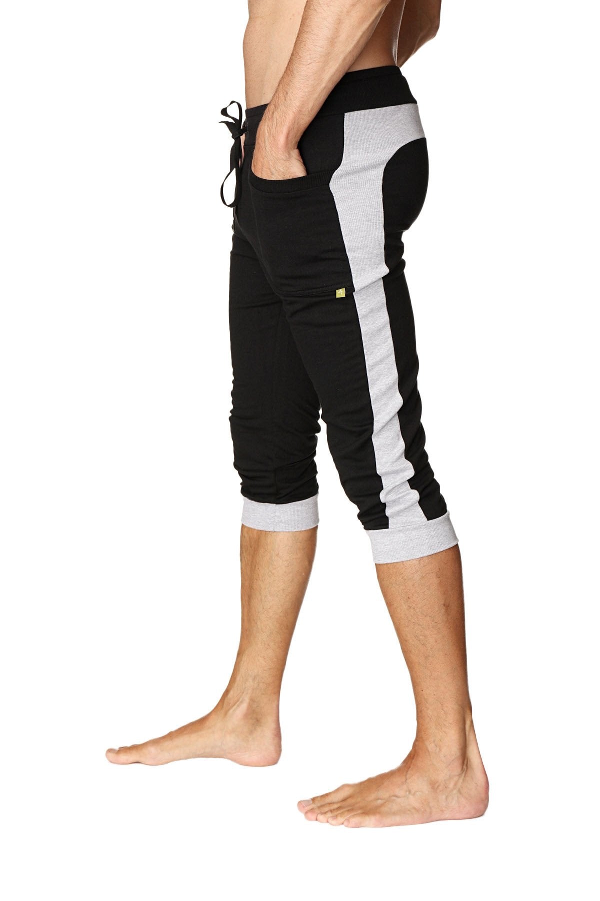 Black and gray cuffed yoga pants with side stripe elastic waistband and rolled cuffs designed for athletic wear
