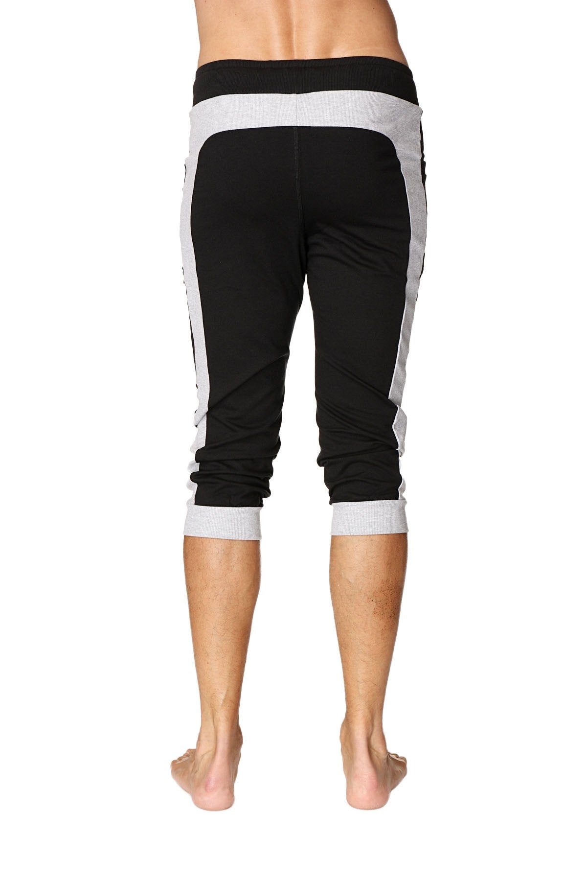 Black and gray cuffed yoga pants with ribbed waistband, side panels, and rolled cuffs for athletic wear