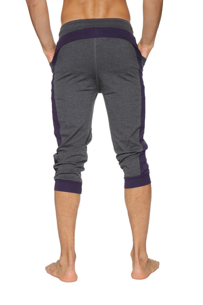 Dark gray and navy blue cuffed yoga pants with ribbed waistband and ankle cuffs in capri length for active wear