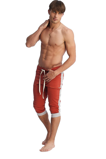 Red athletic shorts with white side stripes and matching drawstring ideal for active wear and casual comfort