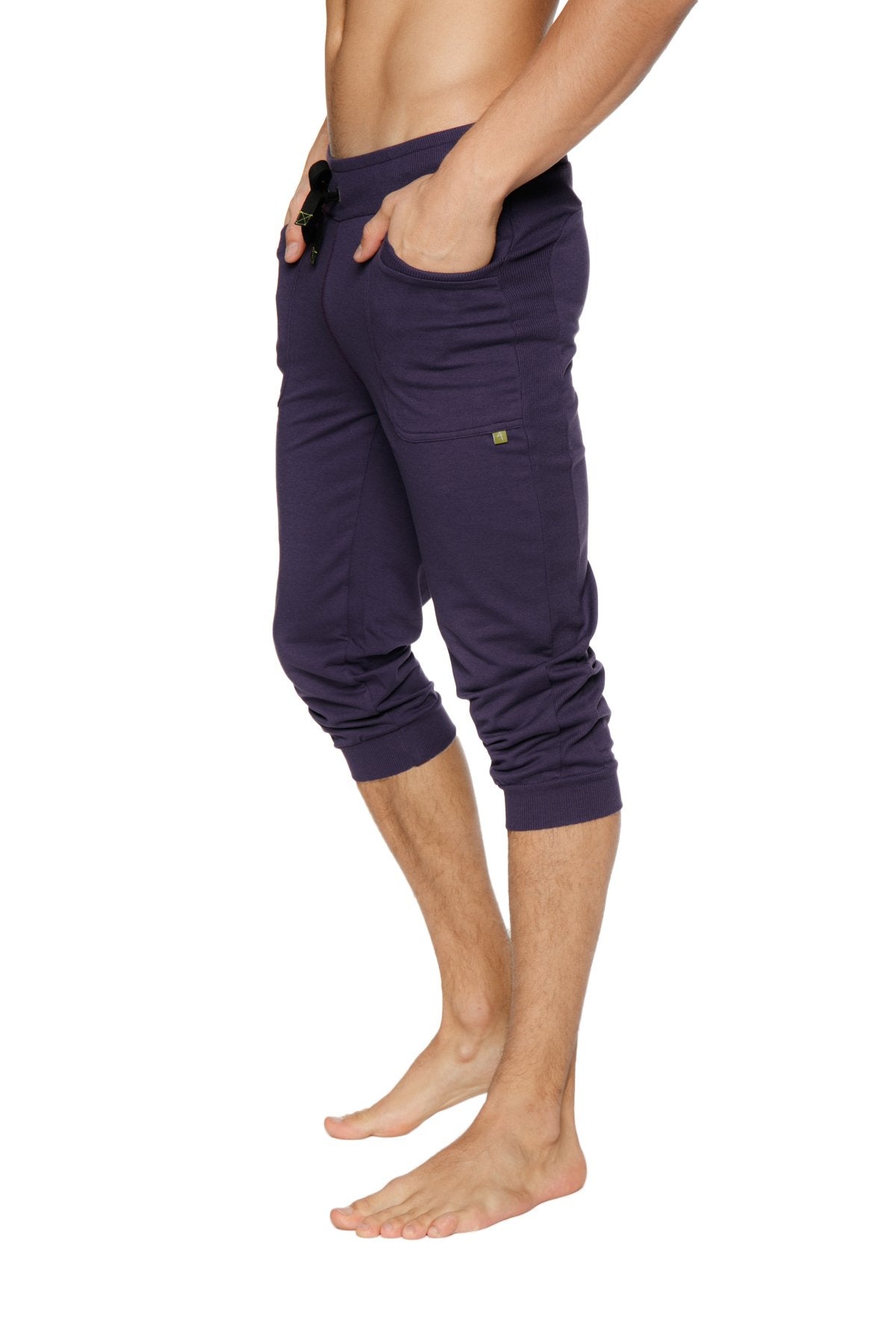 Navy blue cuffed yoga pants with elastic waistband and side pockets in capri-length jogger style