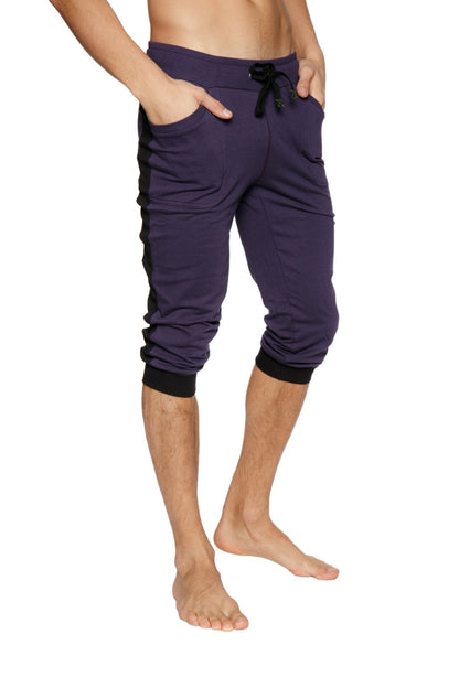 Dark purple capri-length cuffed yoga pants with black side panels elastic cuffs and drawstring waistband