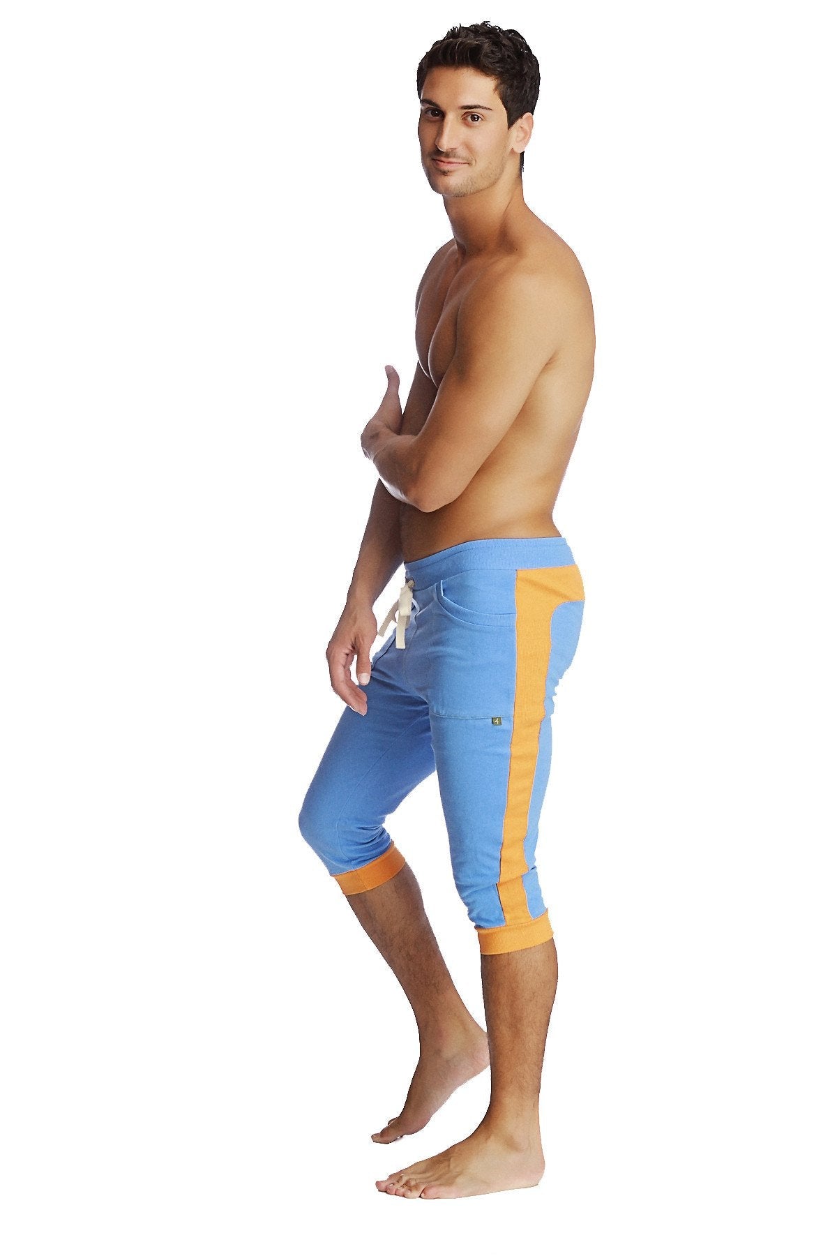 Cuffed yoga pants in ice blue with orange featuring a drawstring waistband and cuffed athletic capri design