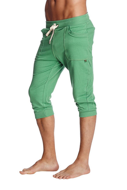 Cuffed yoga pants in solid bamboo green featuring capri-length jogger fit with drawstring waistband and side pockets