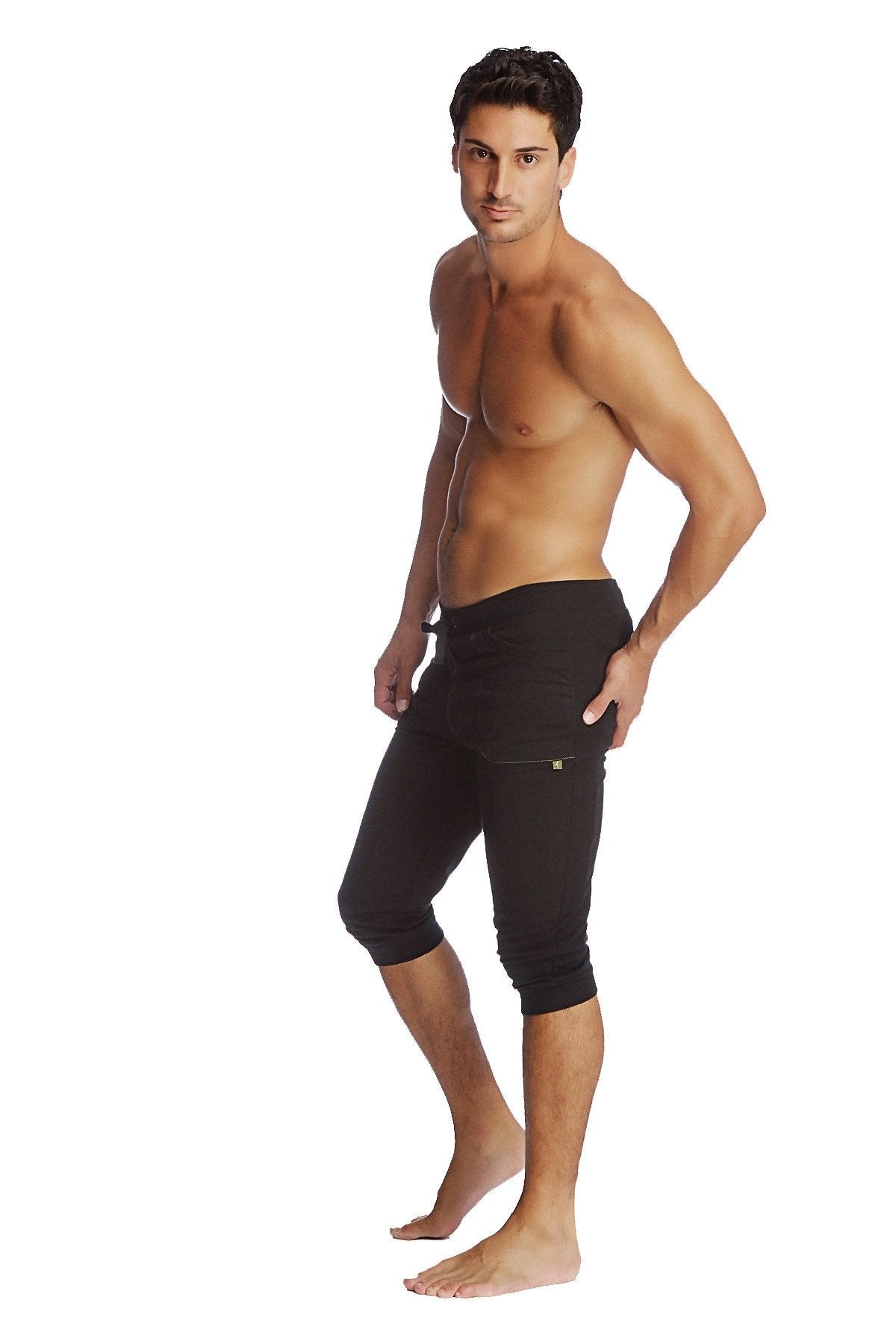 Black cuffed yoga pants with snug fit and subtle side pocket detailing in capri-length athletic style