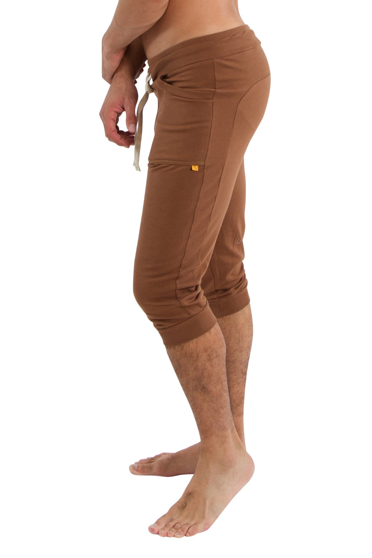 Brown cuffed yoga pants with drawstring waistband and side pockets designed for athletic and casual wear
