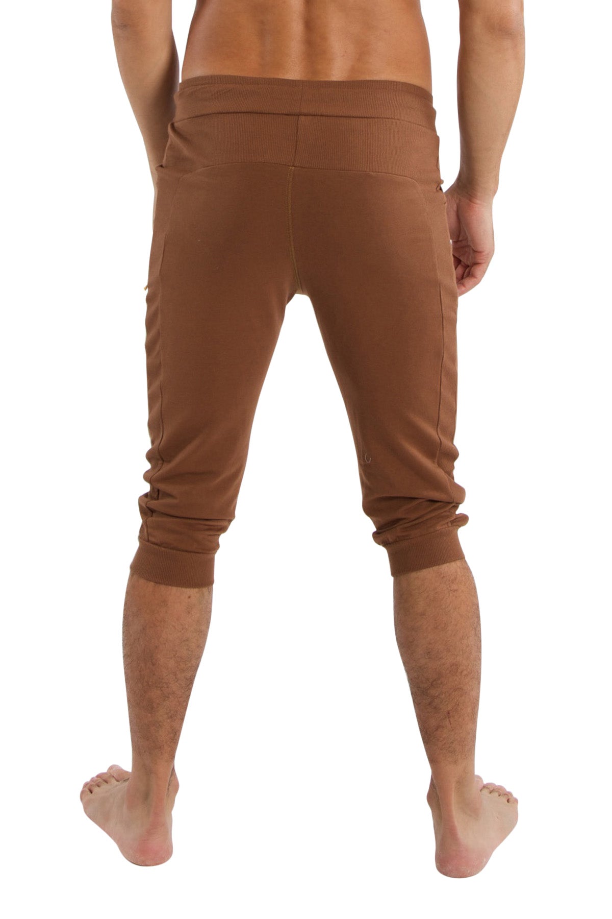 Brown cuffed yoga pants made of stretchy fabric with elastic waistband and rolled cuffs for comfortable wear