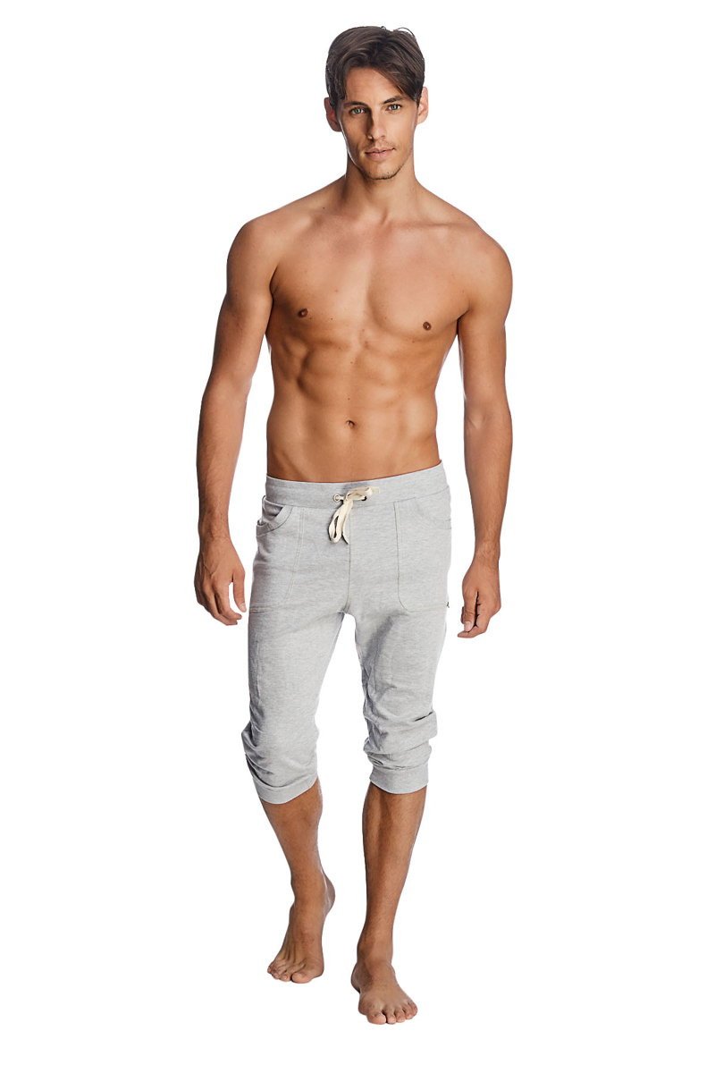 Light gray cuffed yoga pants with drawstring waist and rolled cuffs in mid-thigh length solid heather grey fabric