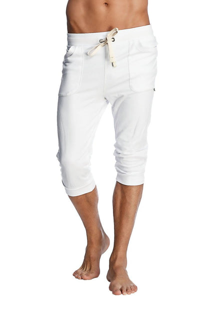White cuffed yoga pants with a drawstring waist and side pockets in a comfortable capri-length fit