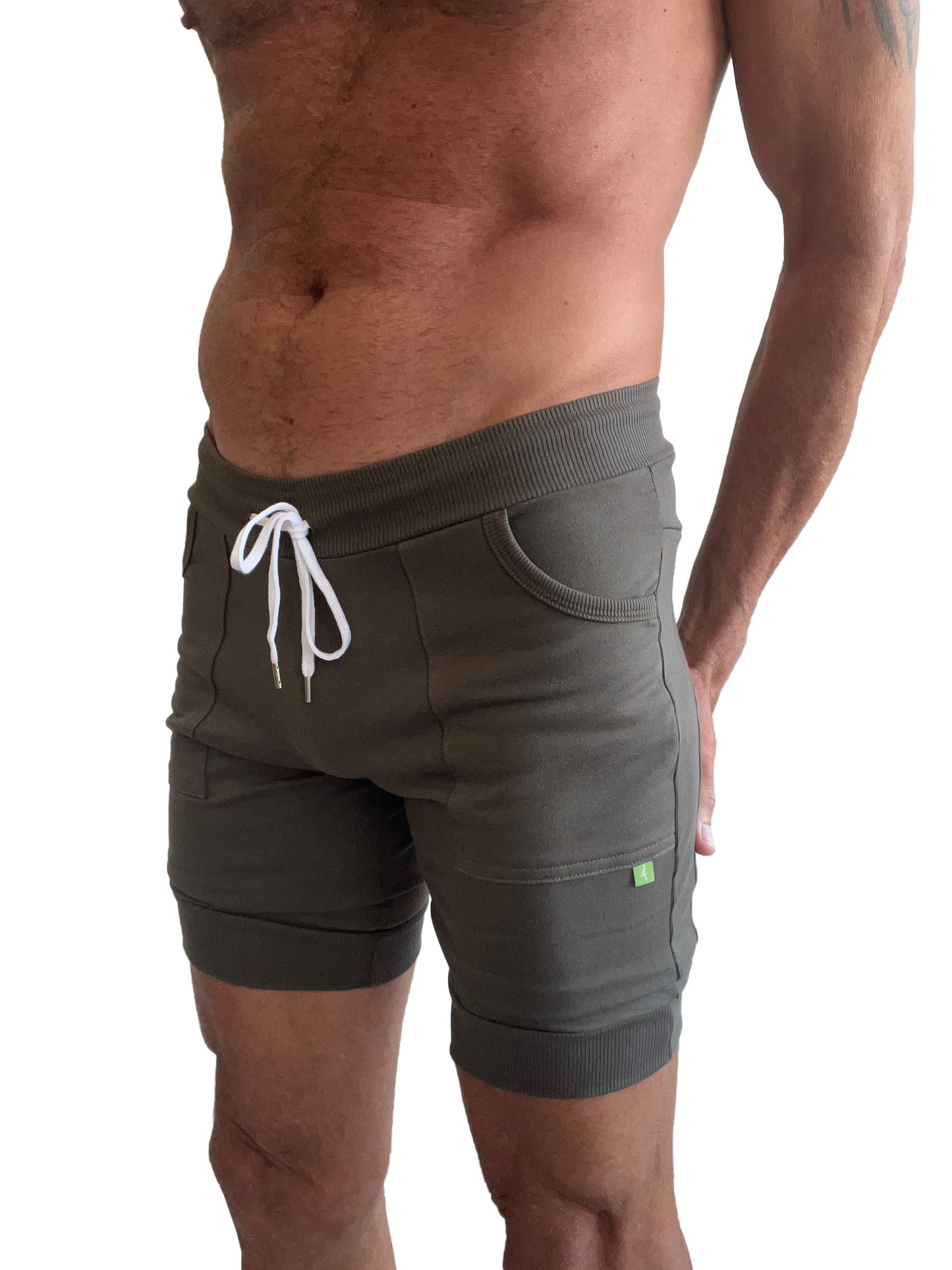Olive green cuffed yoga shorts with white drawstring and ribbed waistband and hem for athletic use