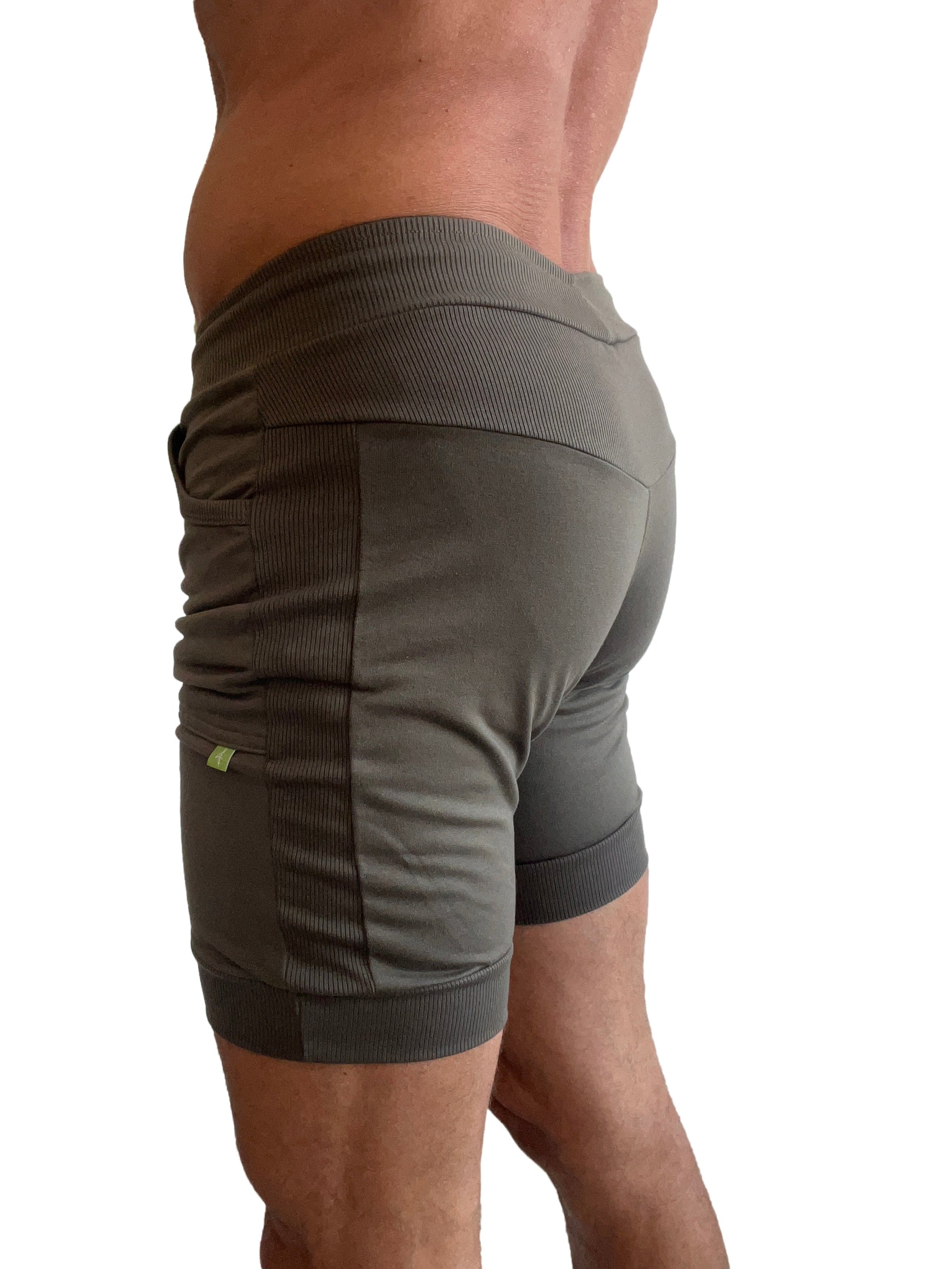 Olive green cuffed yoga shorts with ribbed side panels and elastic waistband for comfortable athletic wear