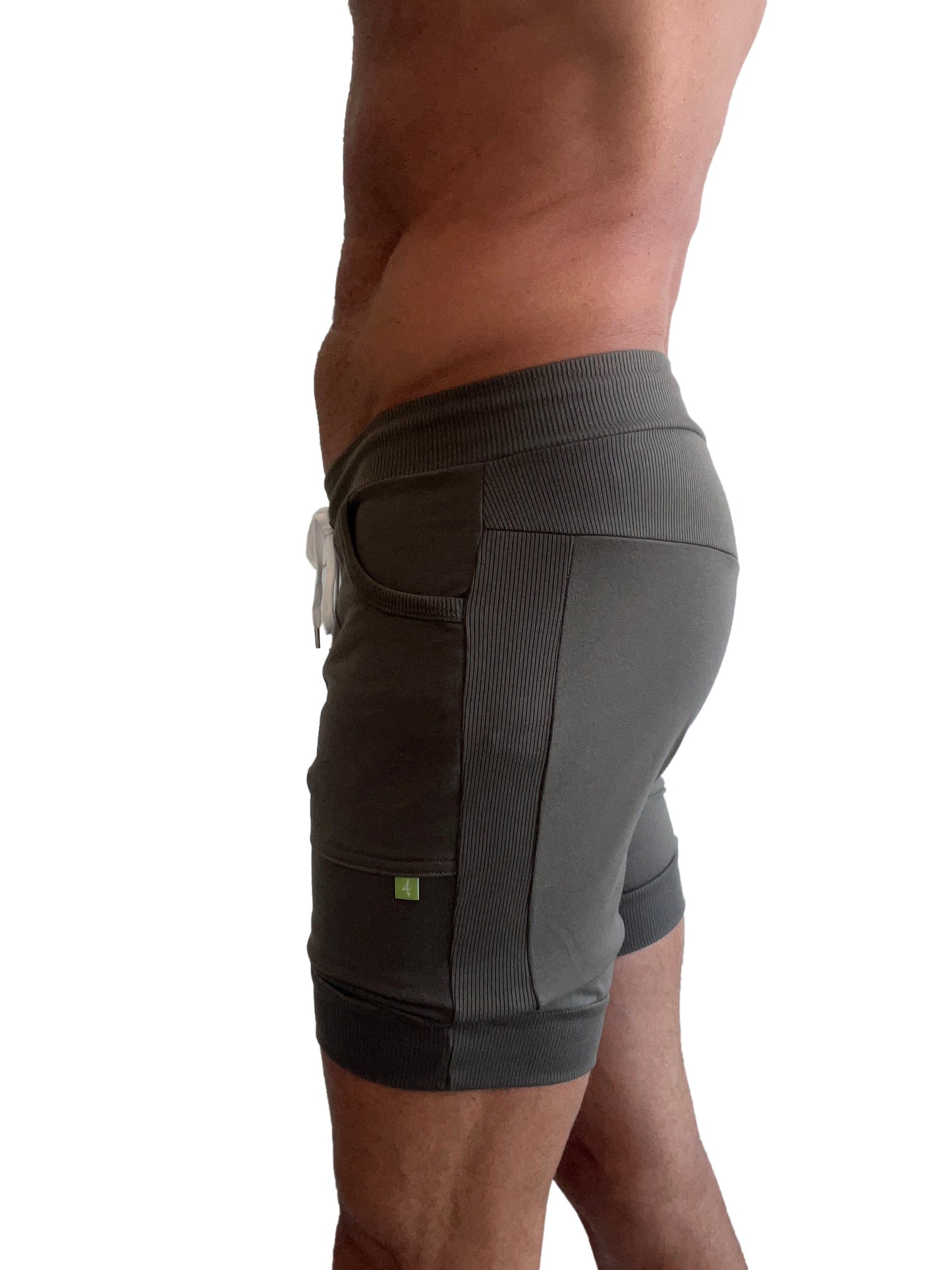 Dark gray cuffed yoga shorts with ribbed side panels and white drawstring for athletic use