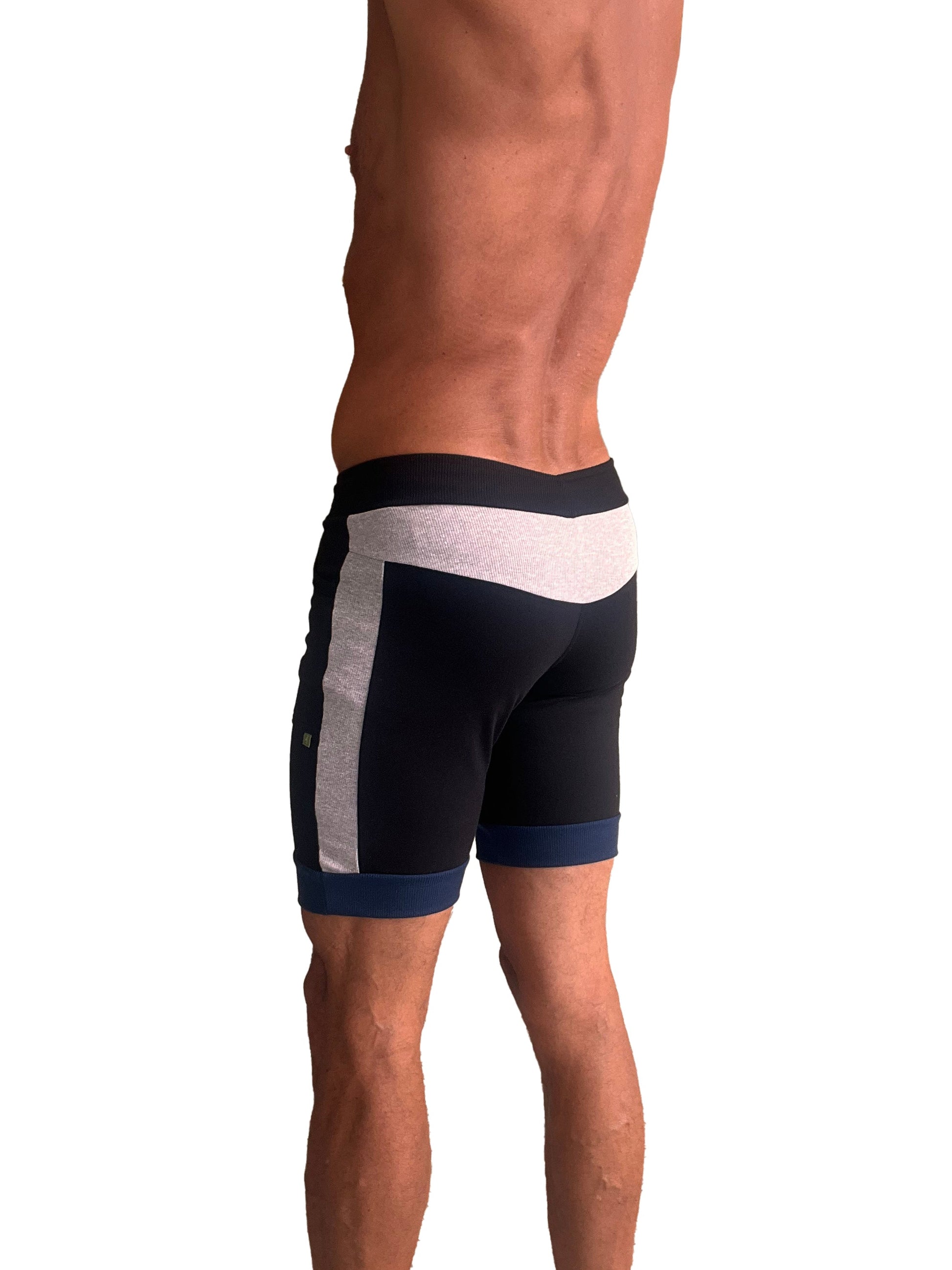 Black cuffed yoga shorts with white and gray side panels and navy trim at waistband and hem