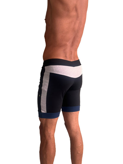 Black cuffed yoga shorts with white and gray side panels and navy trim at waistband and hem