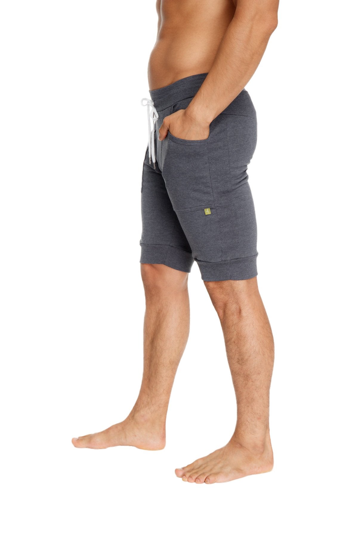 Cuffed yoga short charcoal gray heathered jogger shorts with white drawstring and small green logo on the thigh
