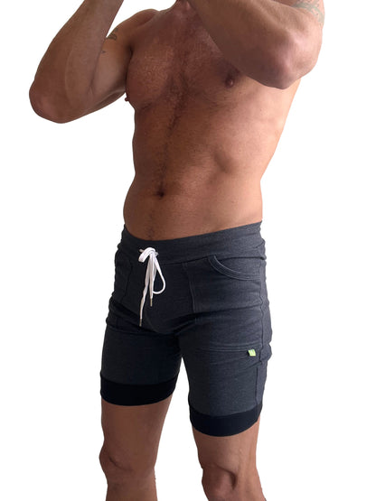 Dark gray cuffed yoga shorts with white drawstring and black trim at cuffs in breathable athletic fabric