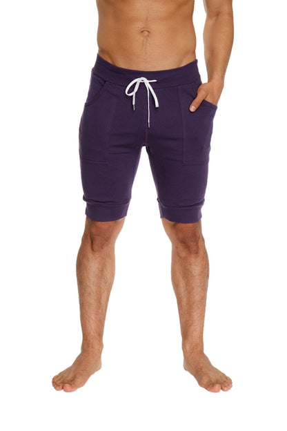 Cuffed yoga shorts in navy blue with white drawstring and side pockets for athletic use