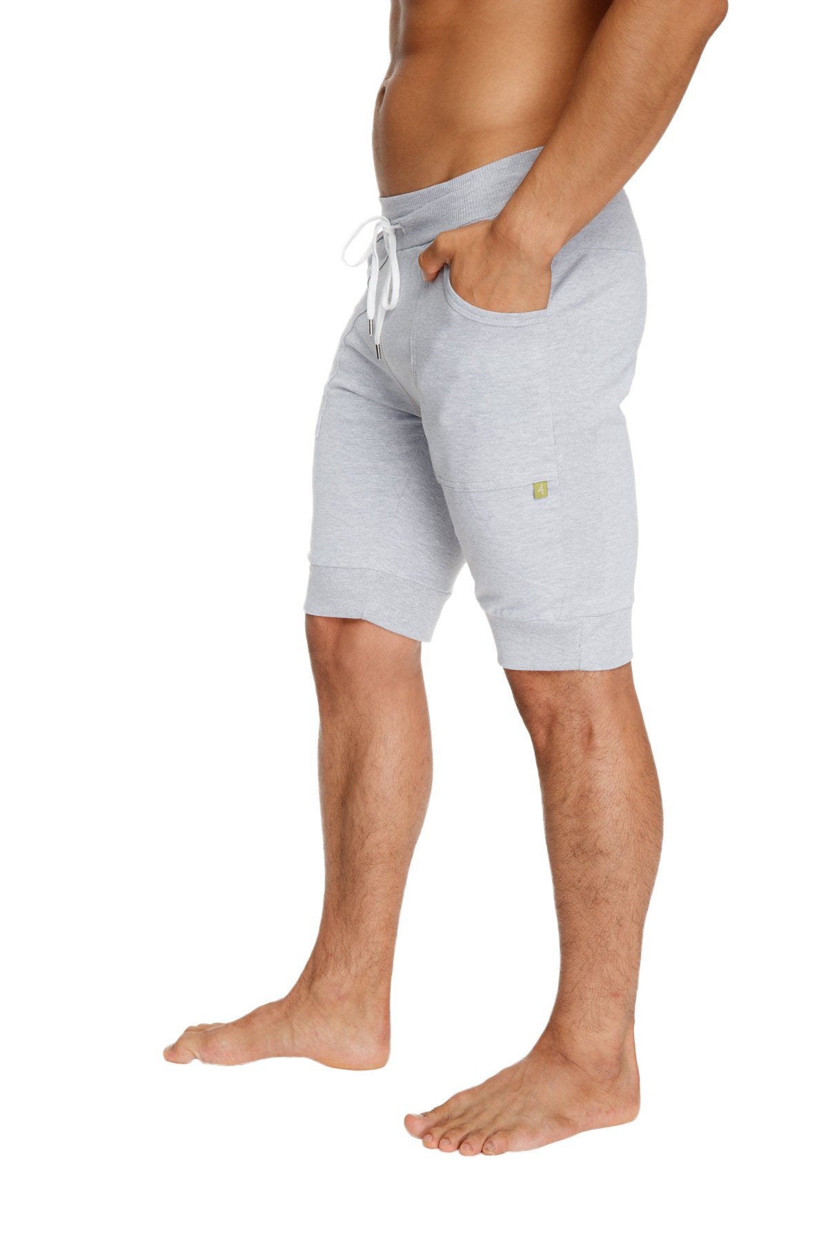 Light gray heathered cotton cuffed yoga shorts with white drawstring and small green logo on the thigh