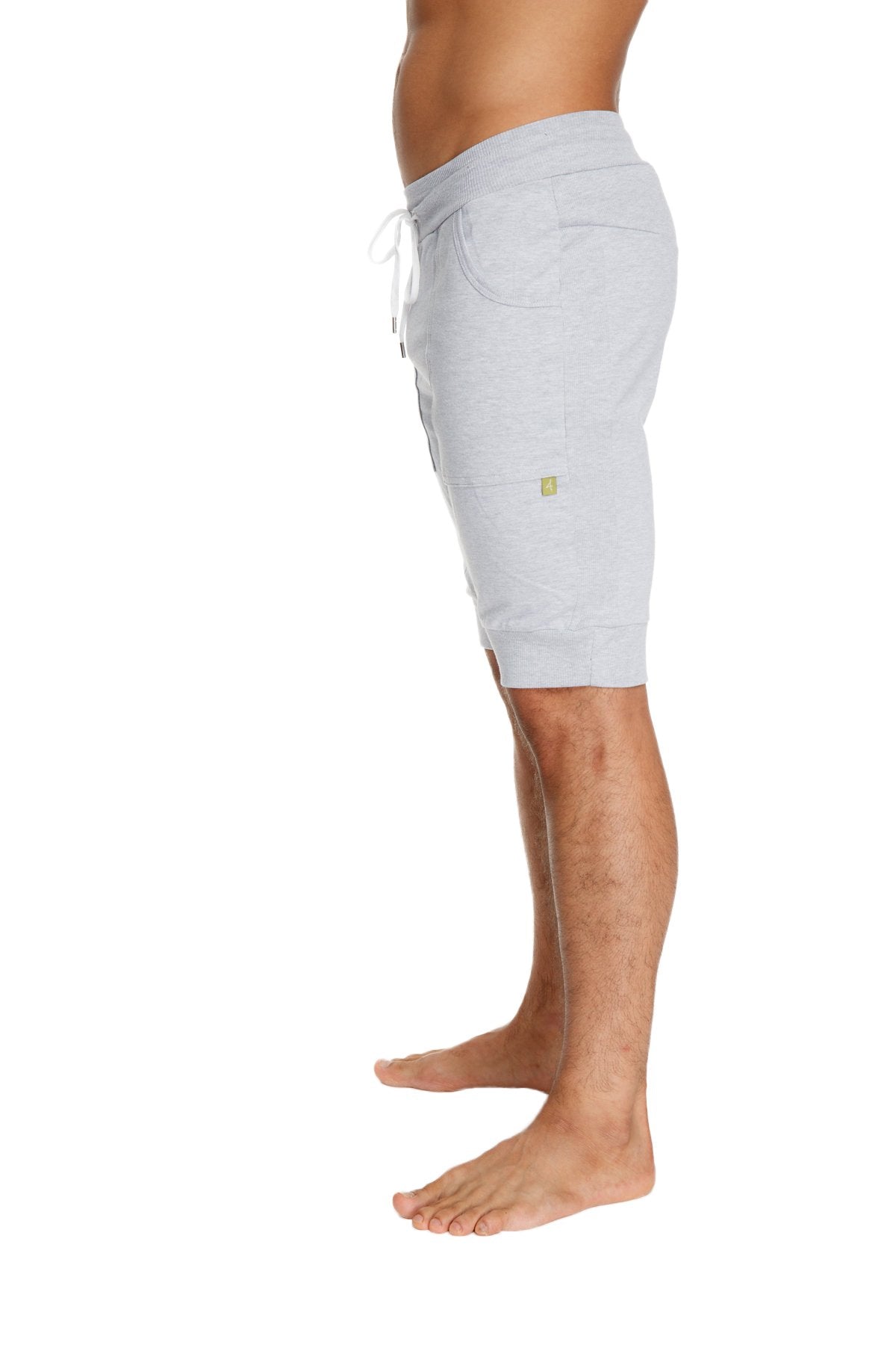 Cuffed yoga short in light gray heathered cotton with white drawstring and small green logo on the side