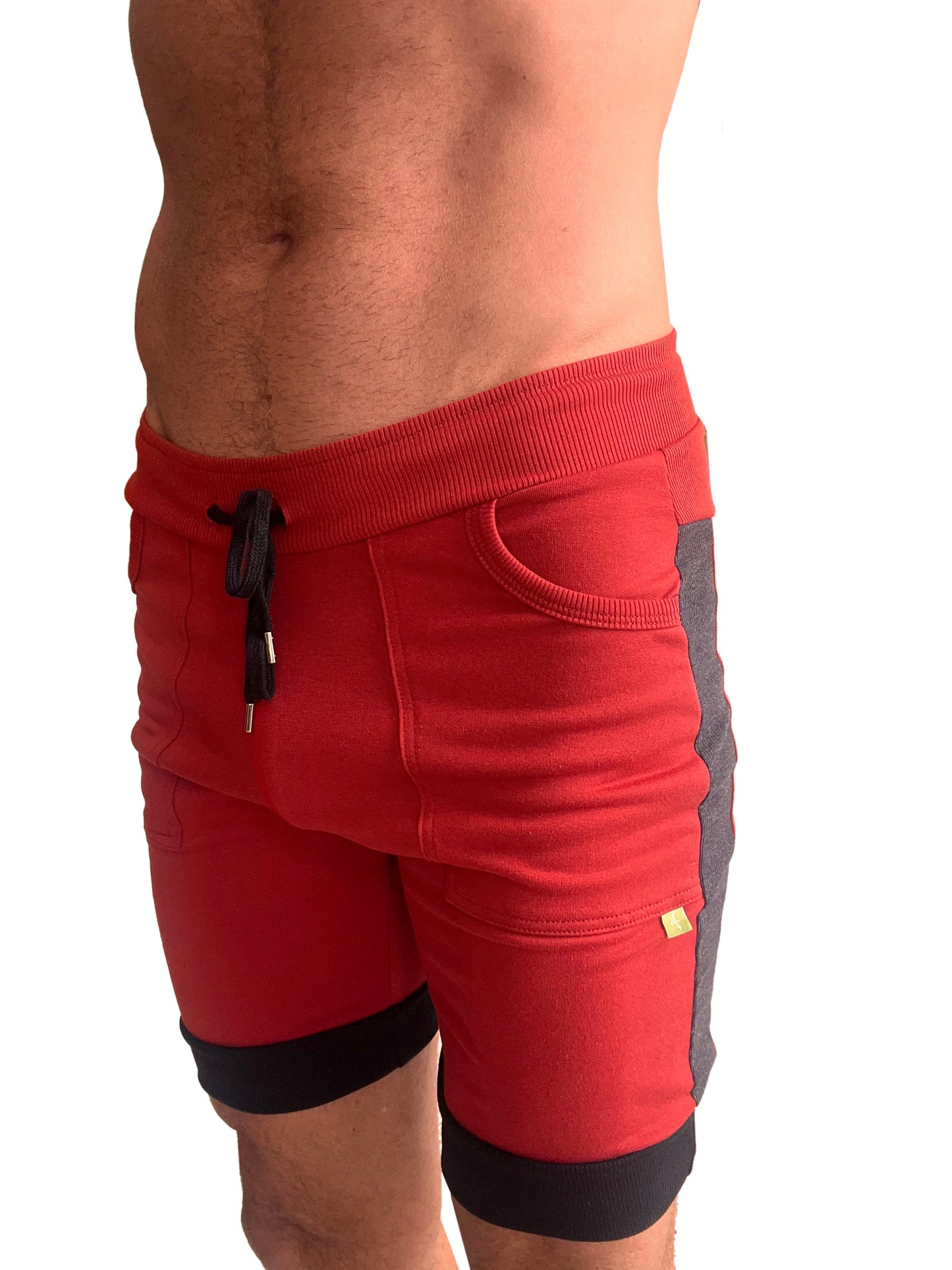 Red cuffed yoga shorts with ribbed waistband black drawstring and gray side panels for athletic use
