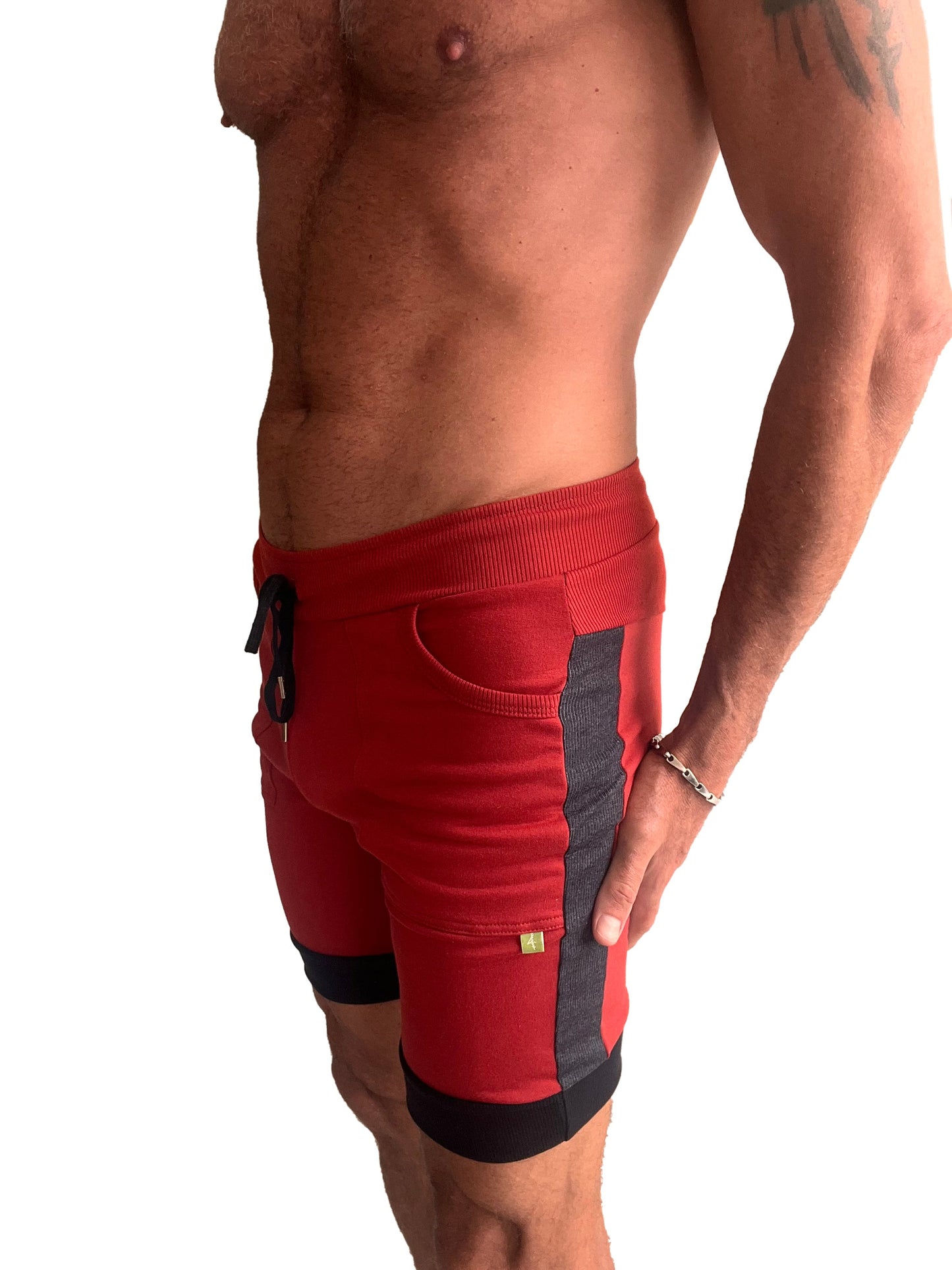 Red cuffed yoga shorts with ribbed waistband and black and charcoal side panels for athletic use