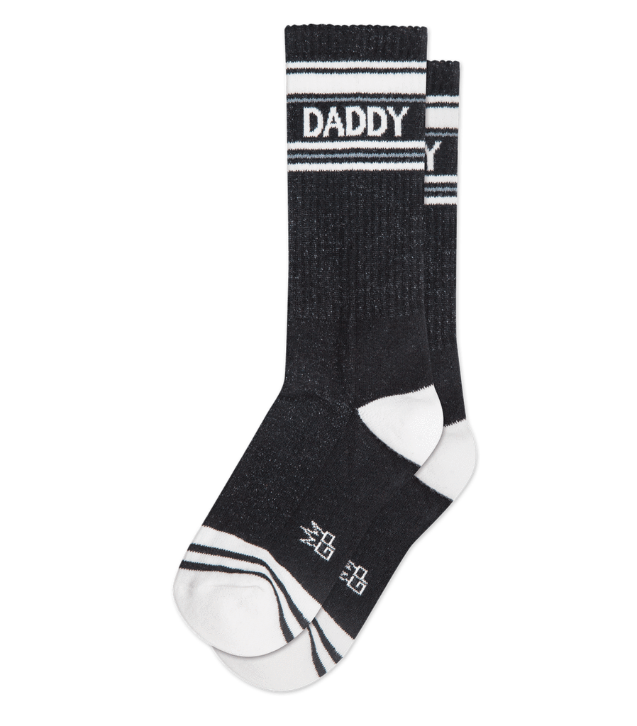 Black daddy crew socks with white stripes made of textured knit material for athletic use