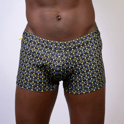 Black designer buckle print sq cut trunk swim trunks with bold yellow and light blue chain-link pattern