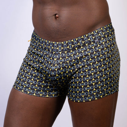 Black swim trunks with bold yellow and blue chain link pattern designer buckle print sq cut trunk front view