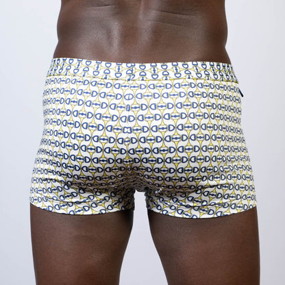White designer buckle print sq cut swim trunks with navy blue and yellow interlocking d-shape pattern