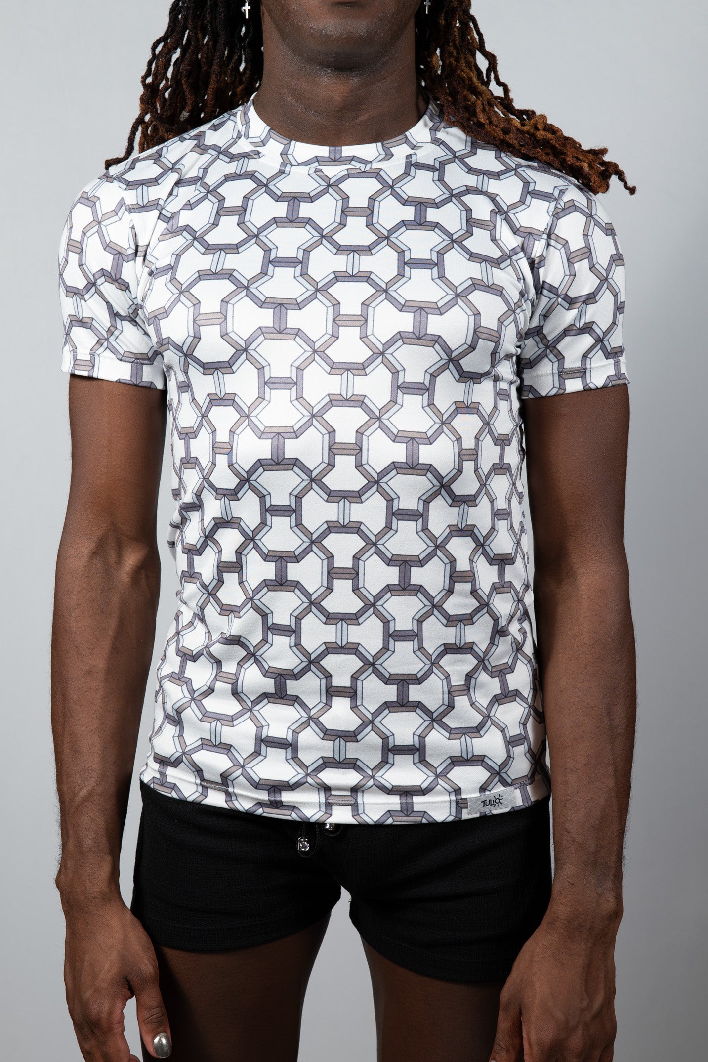 White short-sleeved rash guard with black and gray geometric chain-link pattern inspired by designer print tee
