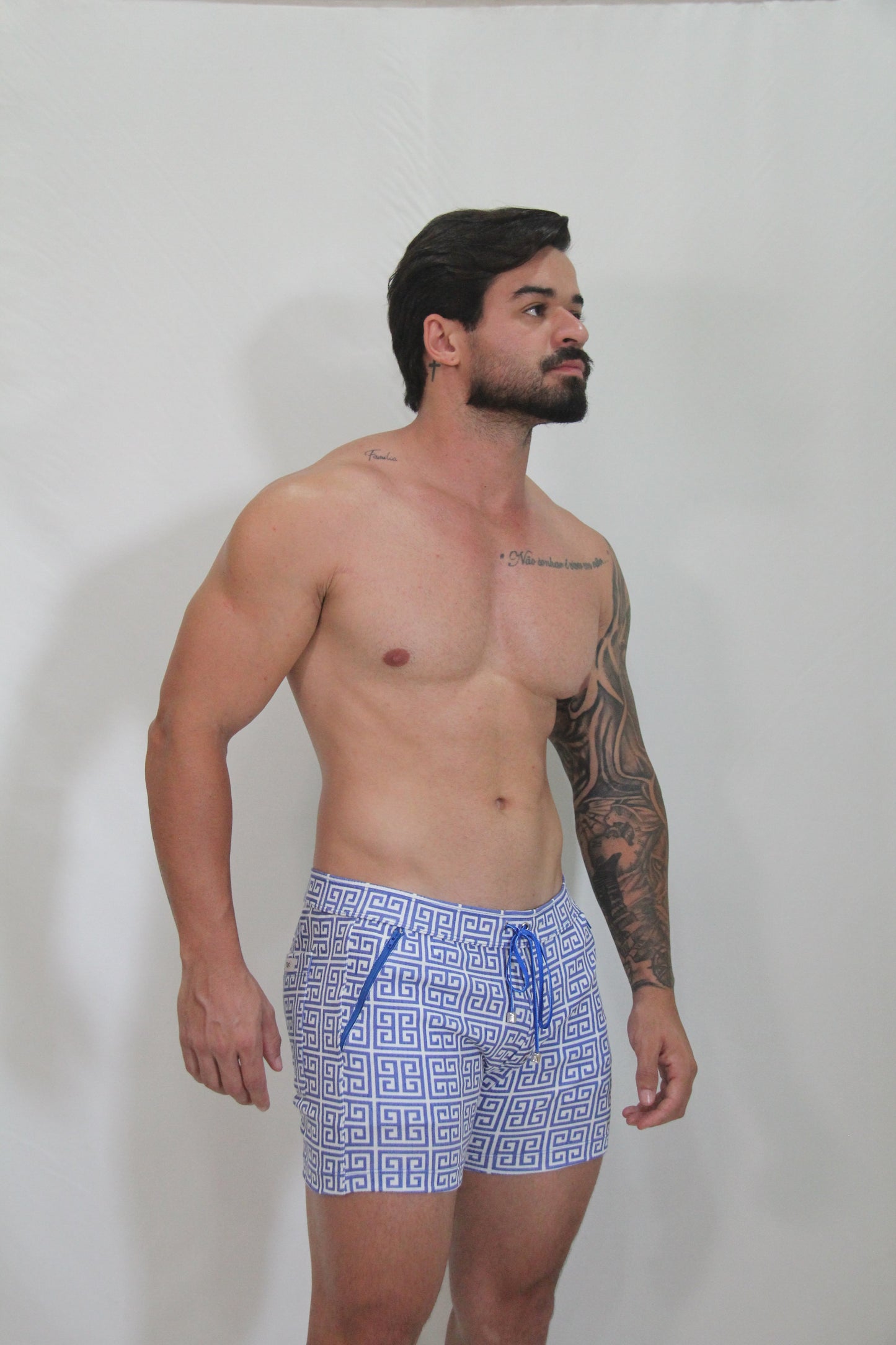 Designer print linen texture shorts in blue and white geometric pattern with matching drawstring swim trunks