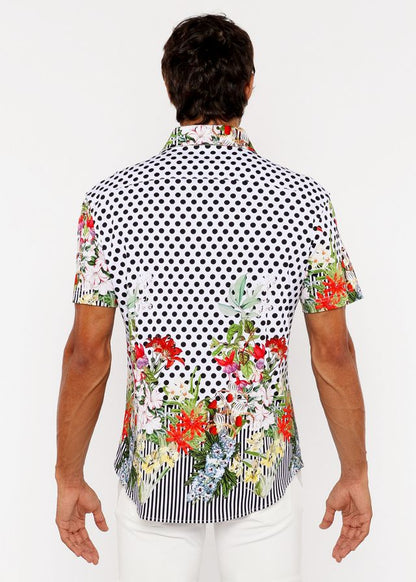 A vibrant short-sleeved men’s woven modal shirt with black and white polka dots and colorful floral border prints