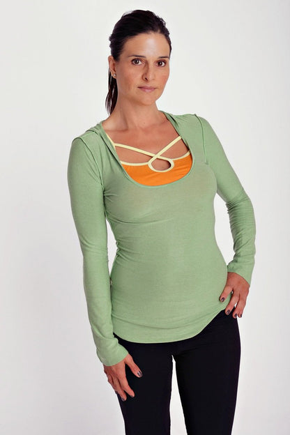 Deep scoop neck long sleeve hoodie top in bamboo green with orange panel and cream crisscross strap detailing