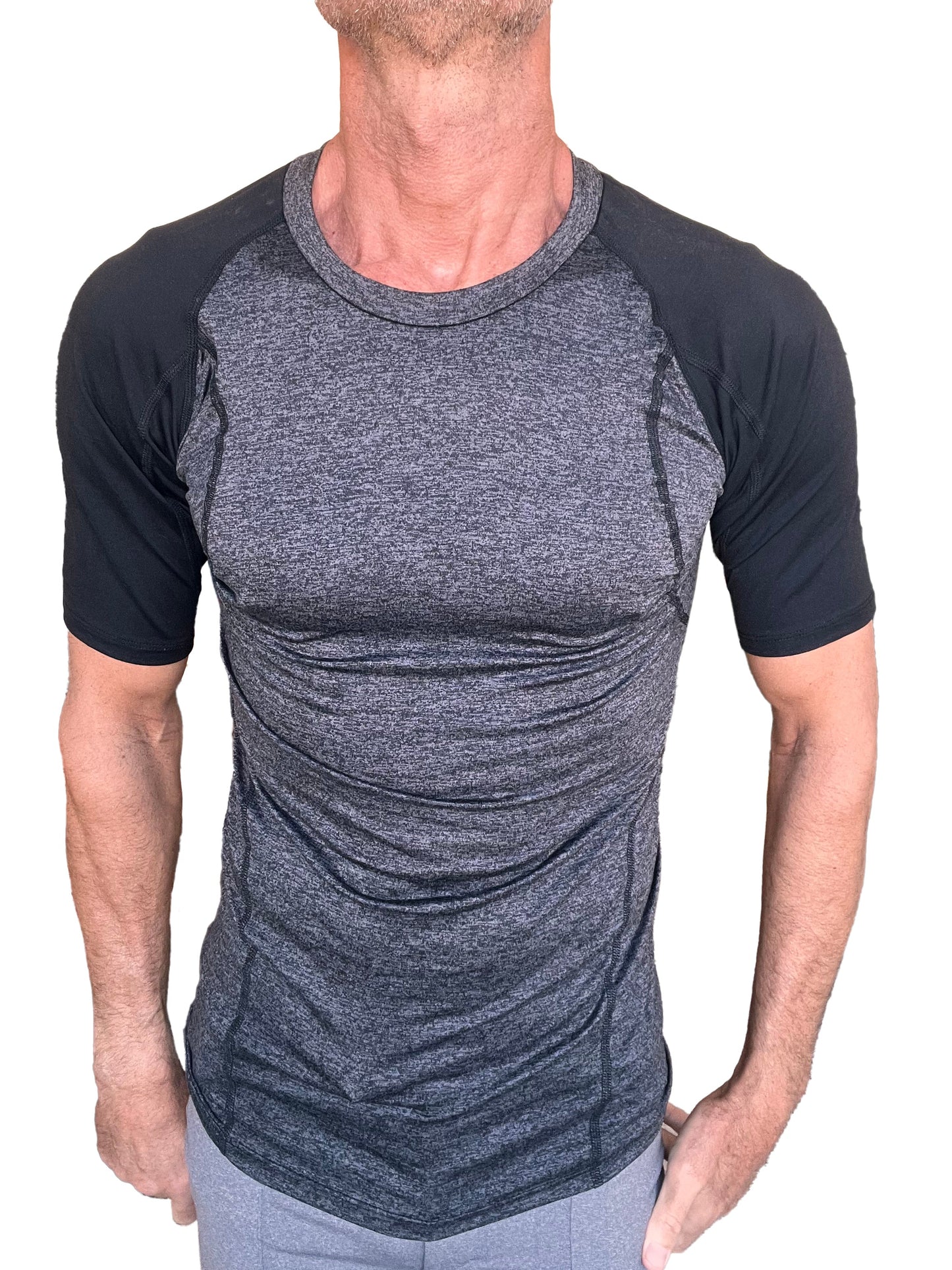 A men’s athletic crew-neck tee with charcoal heathered torso and black raglan sleeves with seam detailing