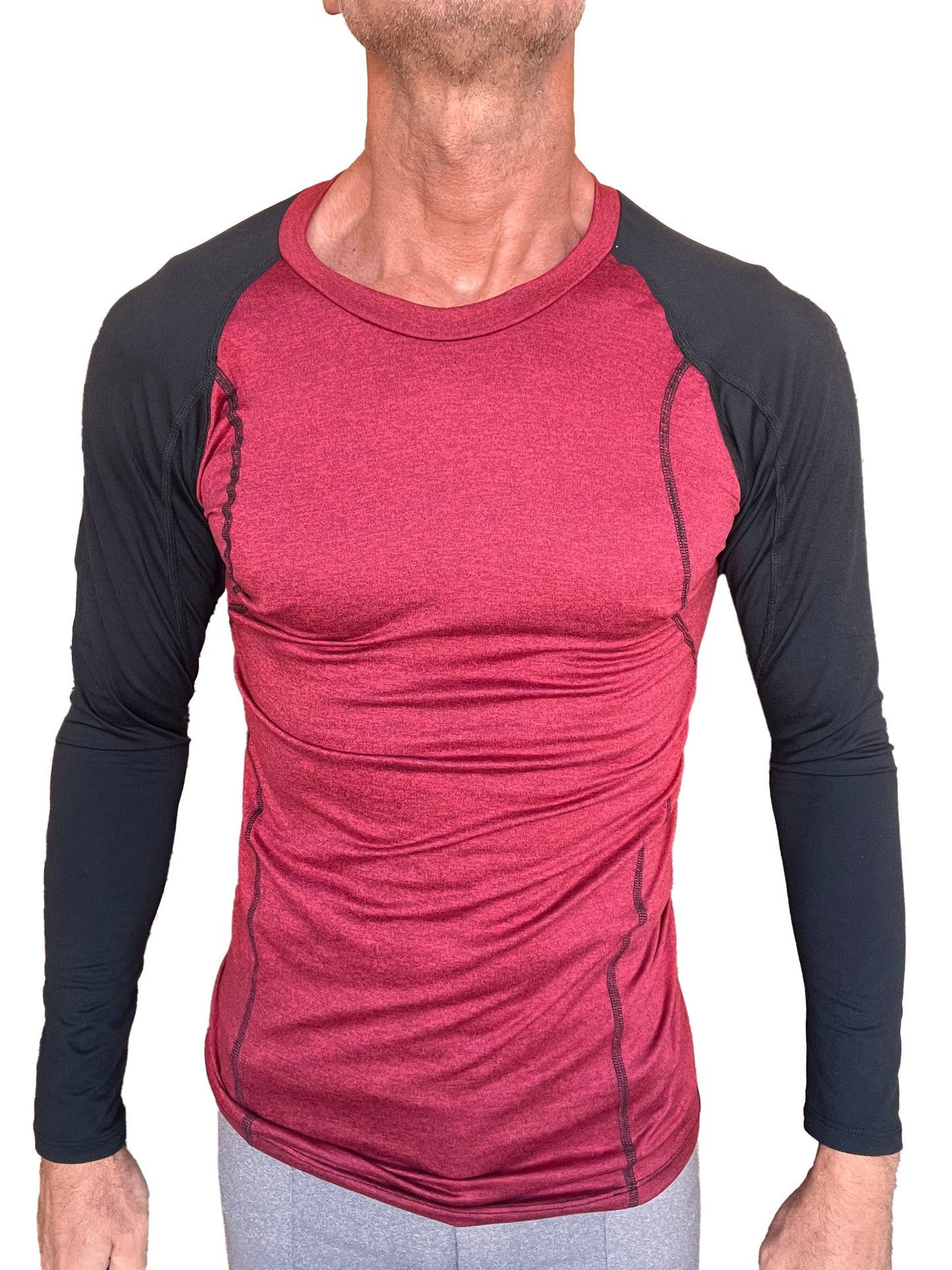 A men’s athletic long-sleeve crew-neck tee with a red heathered torso and black sleeves featuring subtle seam detailing