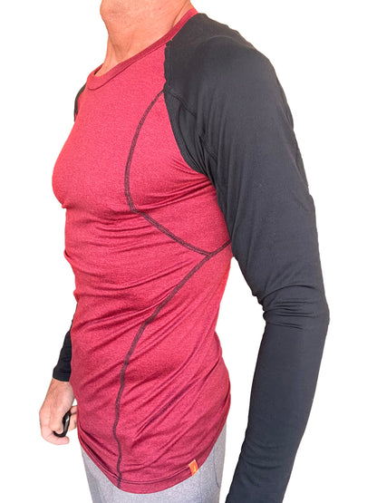 A men’s long-sleeved designer raglan crew-neck tee with a red heathered body and black sleeves with stitching