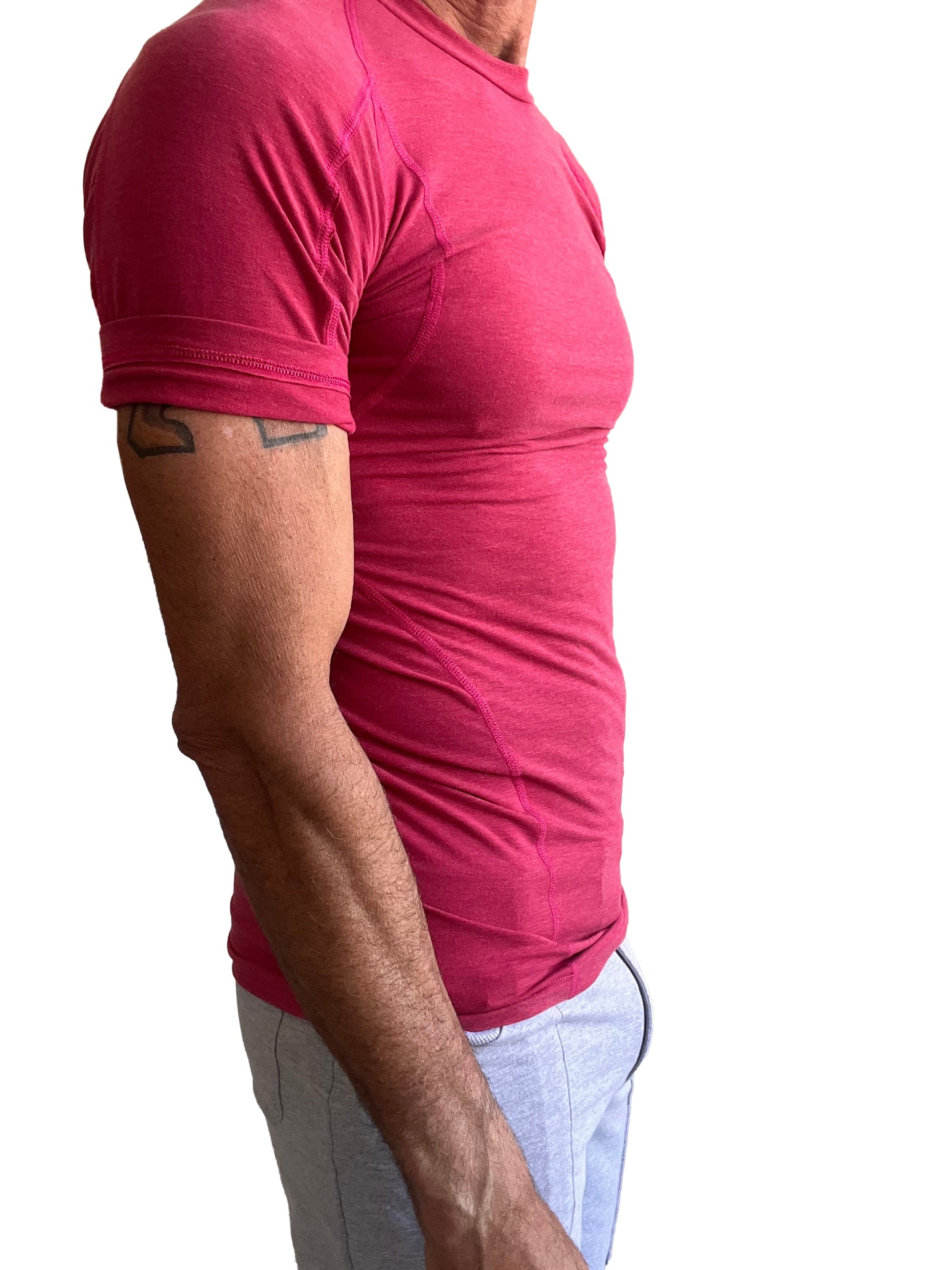 A fitted short-sleeved pink designer raglan crew-neck tee with subtle seam detailing perfect for athletic wear