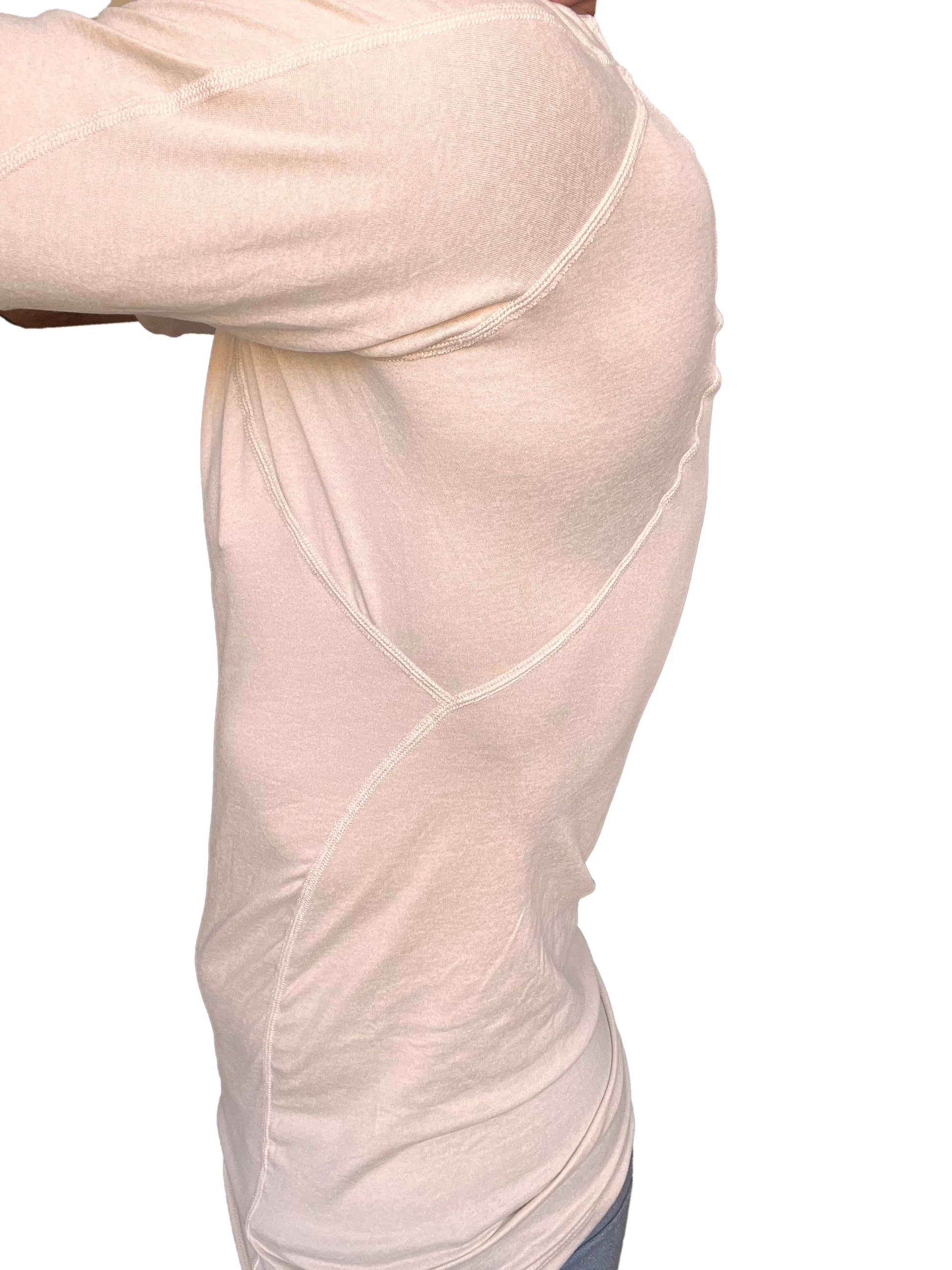 A cream-colored designer raglan crew-neck tee with subtle seam detailing in a form-fitting athletic style