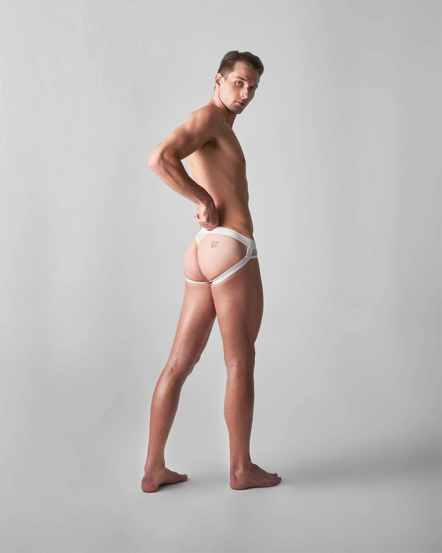 White lace-trimmed edge net jock thong with minimalist design and subtle branding on the front