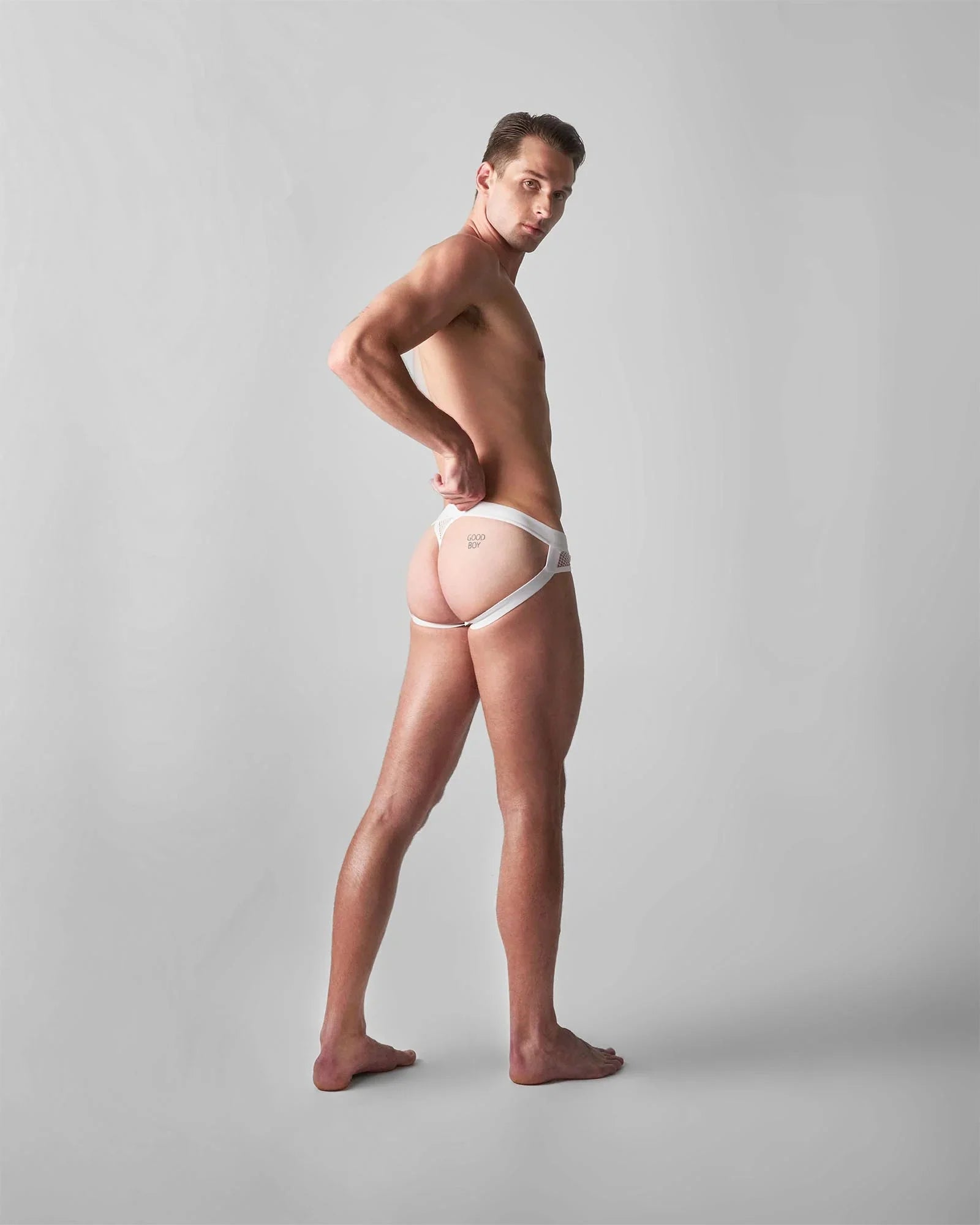 White lace-trimmed edge net jock thong with minimalist design and subtle branding on the front