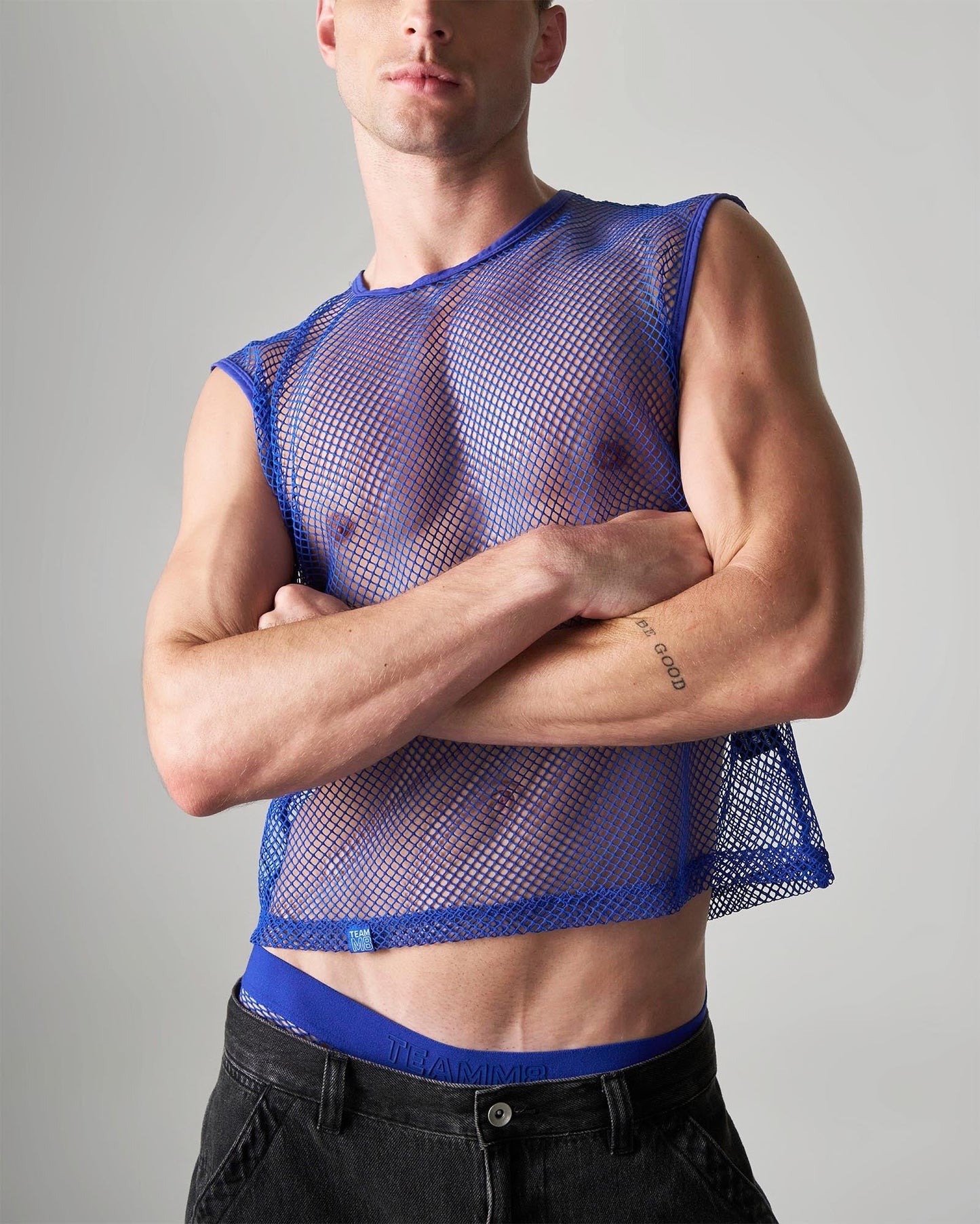 Blue fitted cropped sleeveless top made of mesh material designed as an edge net mesh muscle tank