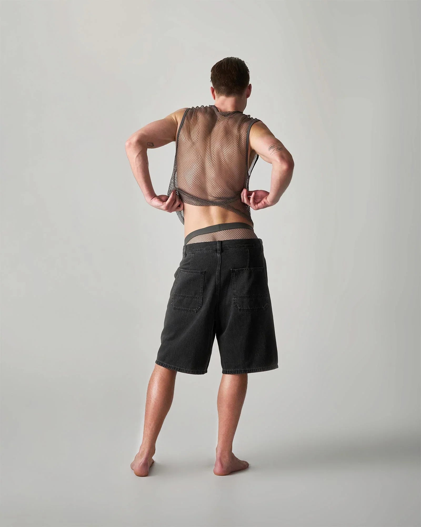 Black edge net mesh muscle tank with adjustable straps and sheer semi-transparent design in breathable fabric