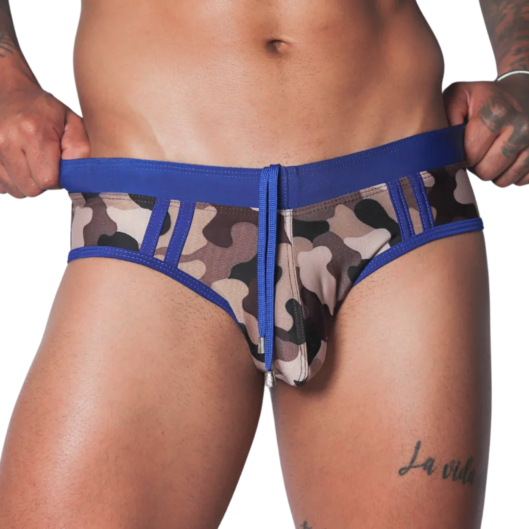 Blue camo swim brief with solid blue waistband, matching drawstring, and panel detailing on a fitted athletic cut.