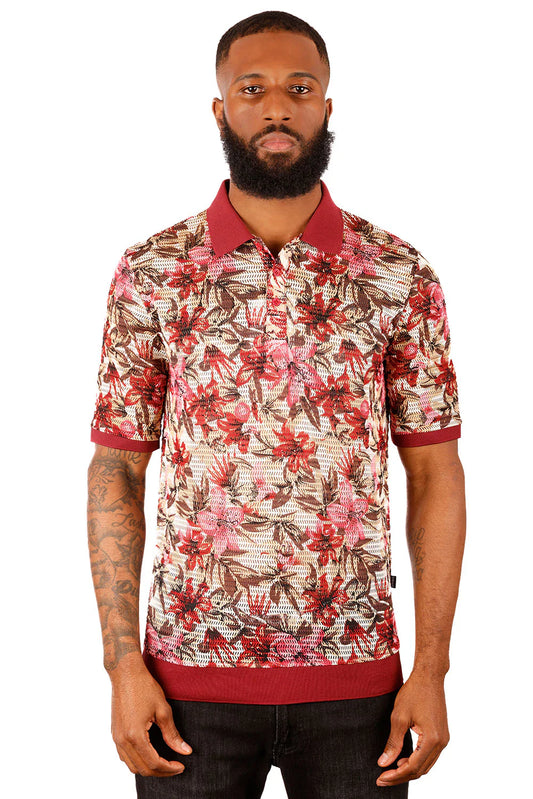 A man wearing an entwine form polo shirt with red and brown floral pattern on light beige with maroon trim