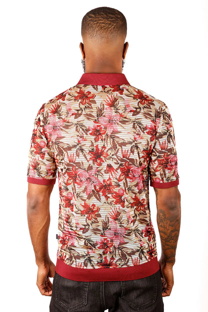 A man wearing an entwine form polo shirt with red pink and brown floral pattern on beige mesh with maroon accents