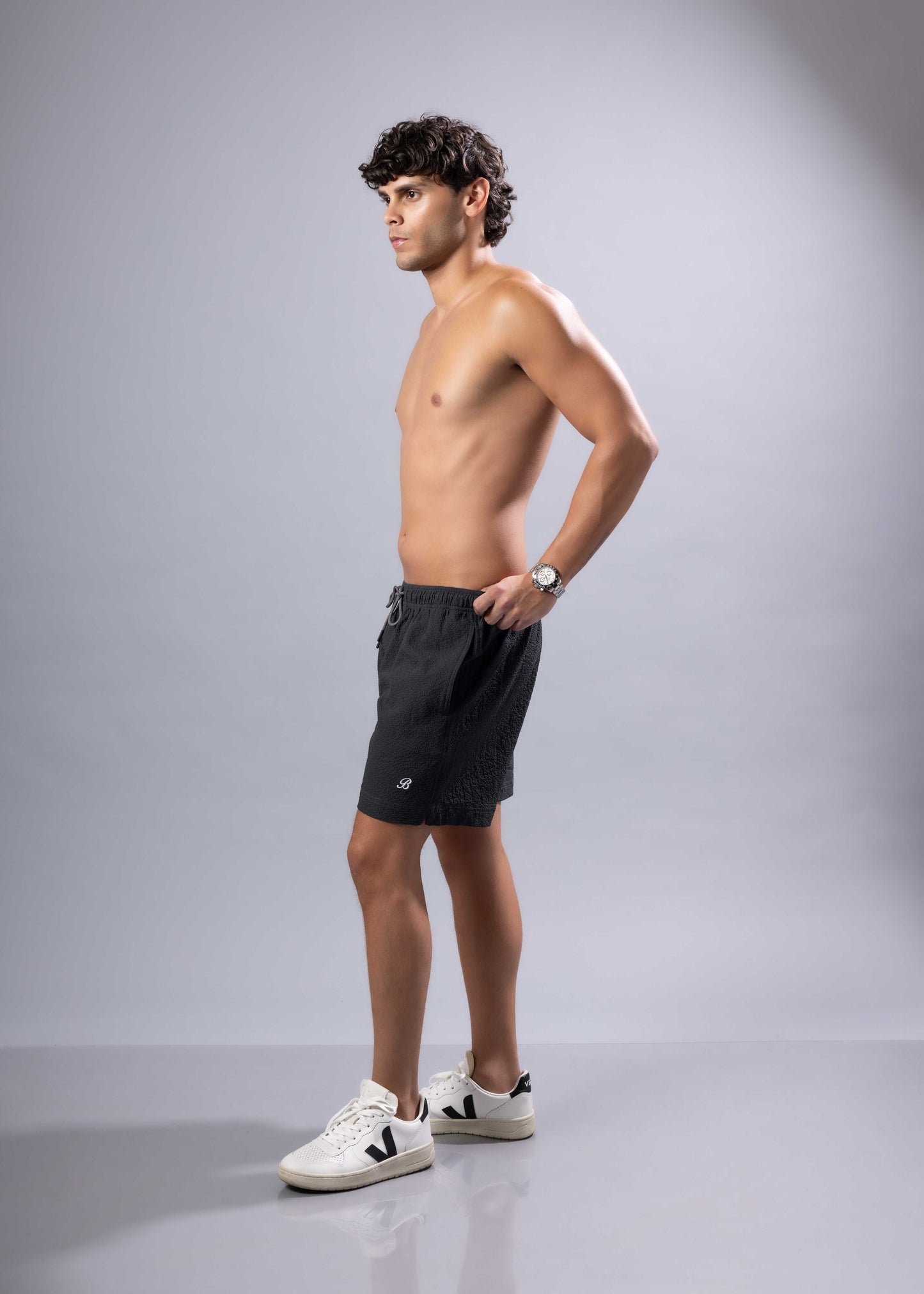 Black essential swim short with subtle textured pattern and small logo on lower left leg available in 3 colors