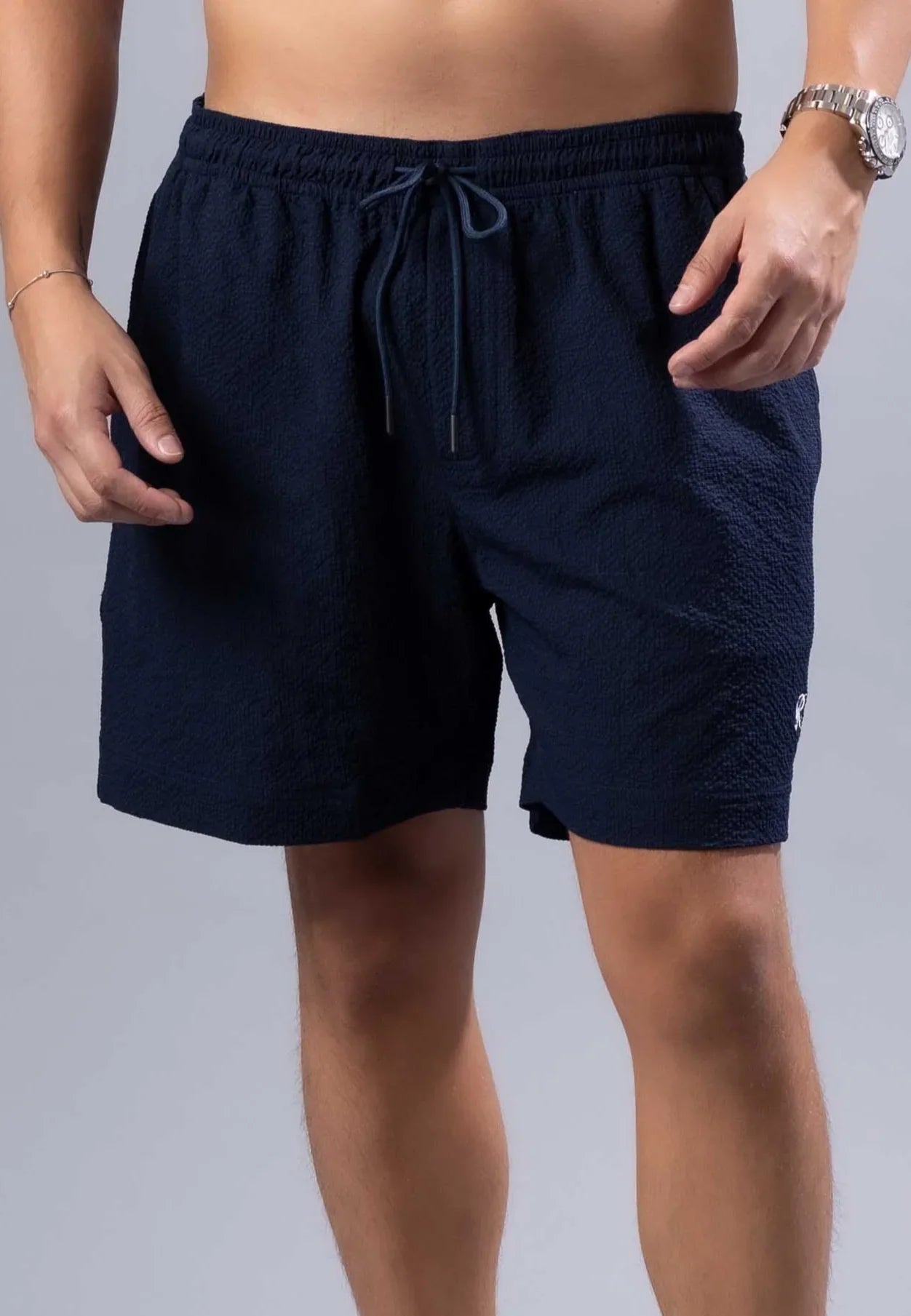 Navy blue textured essential swim short with matching drawstring waistband available in three colors