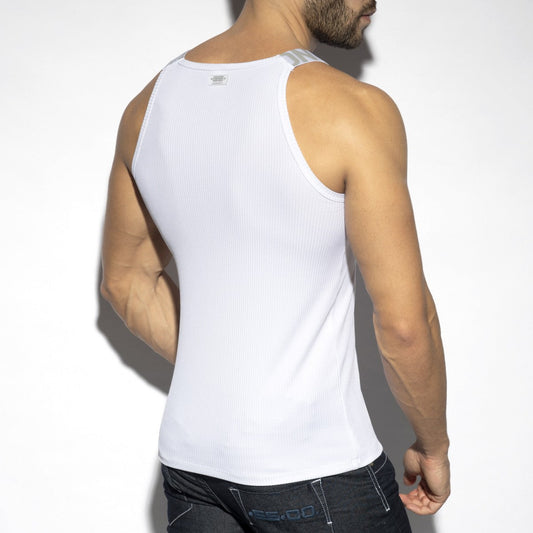Rear view of a person wearing a white ribbed tank top and dark jeans.